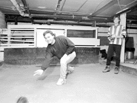 Curt Chapman rolls a rolle bolle Curt Chapman, left, rolls a rolle bolle toward the stake in the basement of the Friends' Circle Club in Moline.a friendly game in Moline, Iowa